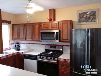 Open tropical living room with natural light, wicker furniture, and tile floors in Las Lajas Panama
