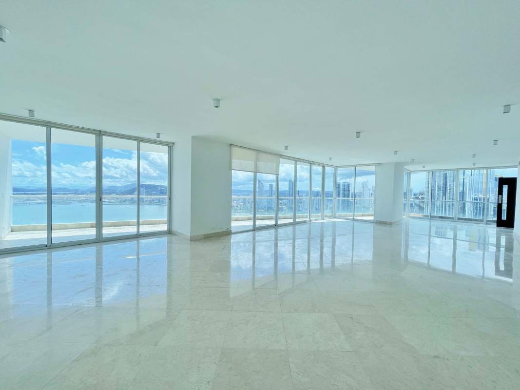 Elegant living and dining open space with marble floors, panoramic windows showing ocean and skyline in PH The Point