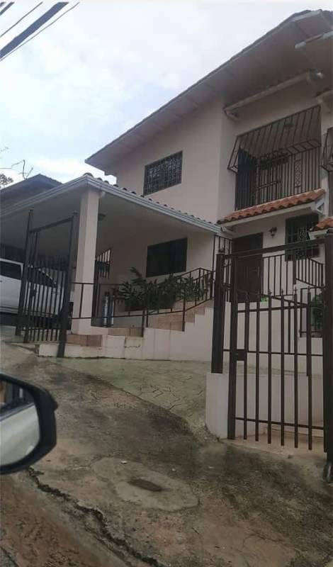 Two-story suburban house with secure gated entrance and covered carport in Villa de las Fuentes Panama City