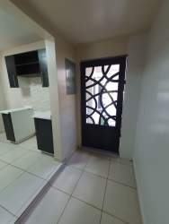 Modern L-shaped kitchen with granite countertops and breakfast bar PH Summer Hills Costa Verde Panama