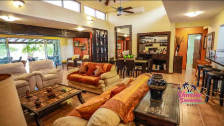 Spacious covered patio and shaded bohío surrounded by gardens and palm trees at Costa Blanca Golf & Villas Panama