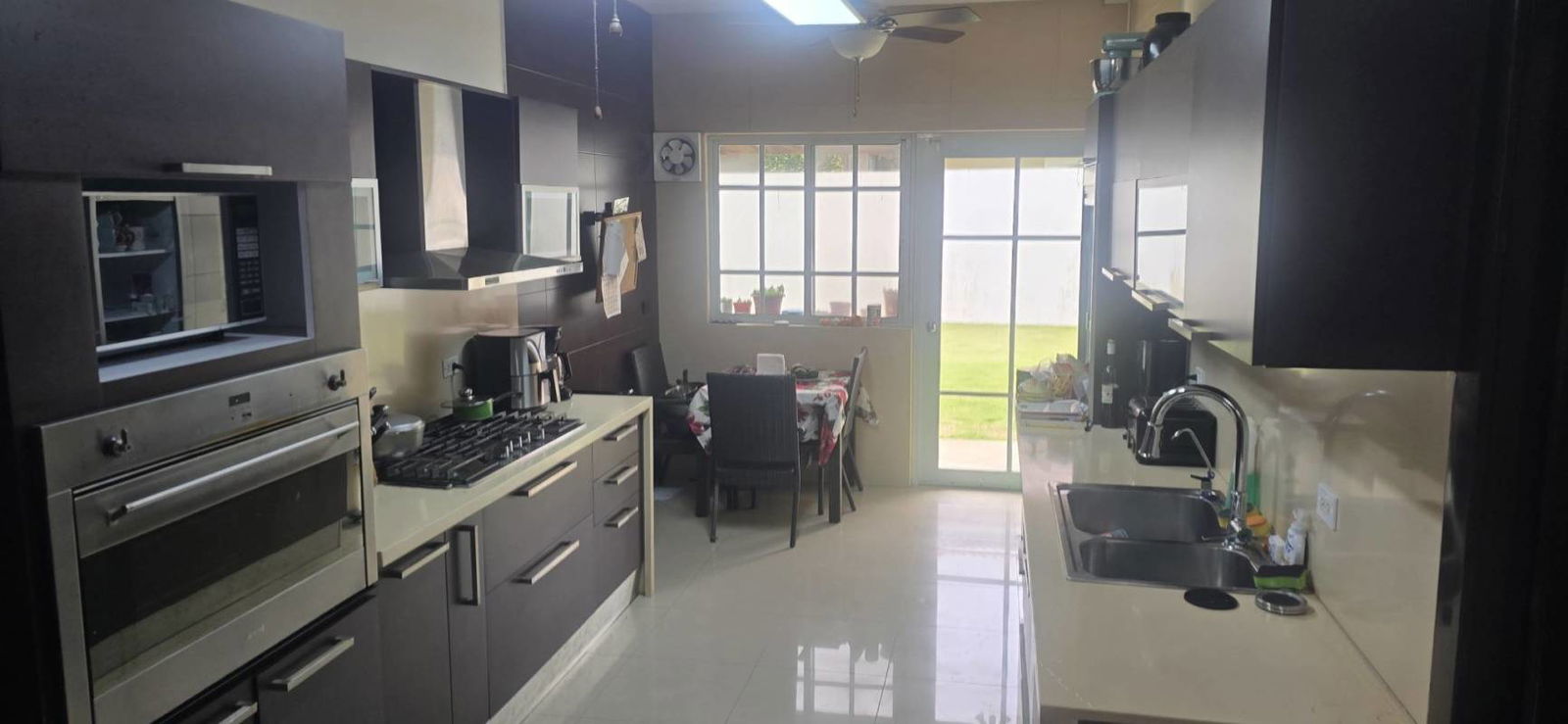 Open living dining area with contemporary furnishings and accent wall decorated for holidays Costa del Este Panama