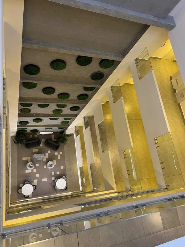 Spacious multi-story lobby atrium with modern design lounge furniture at PH Coco Place Panama