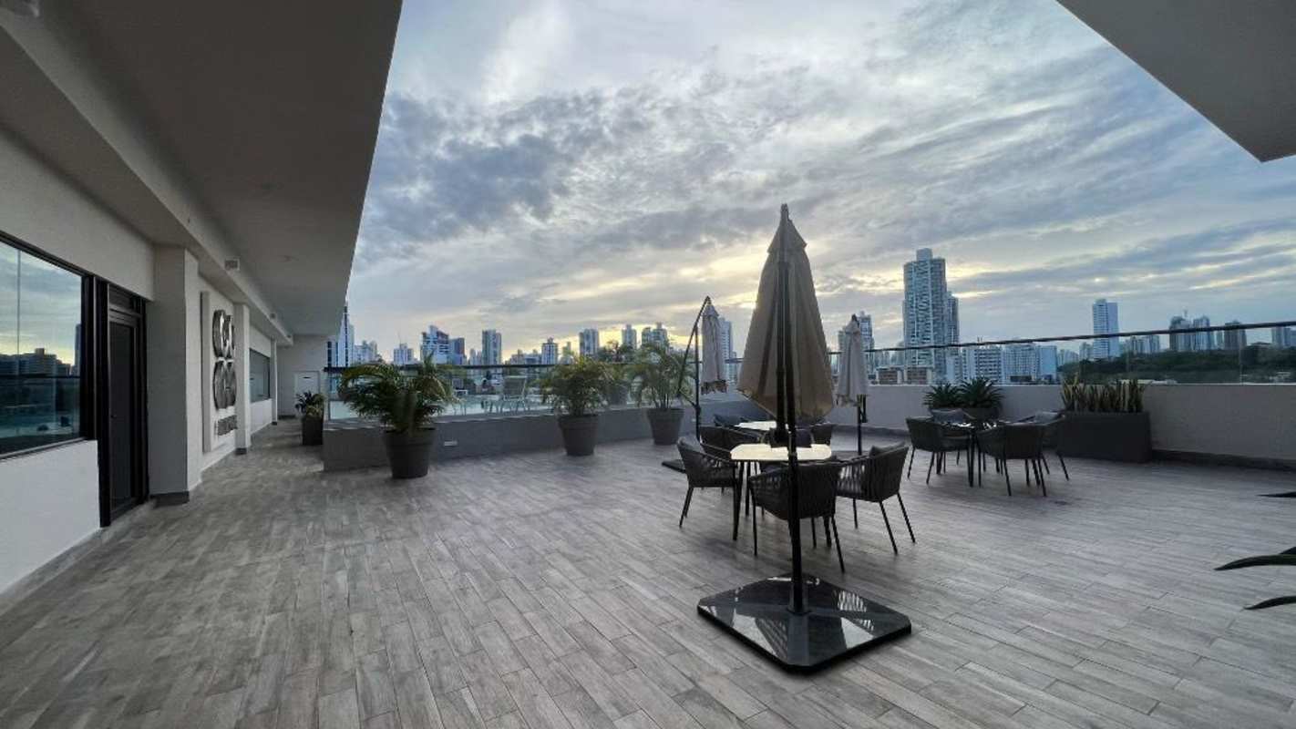 Rooftop terrace with glass railing, city view, seating areas at PH Coco Place Panama City
