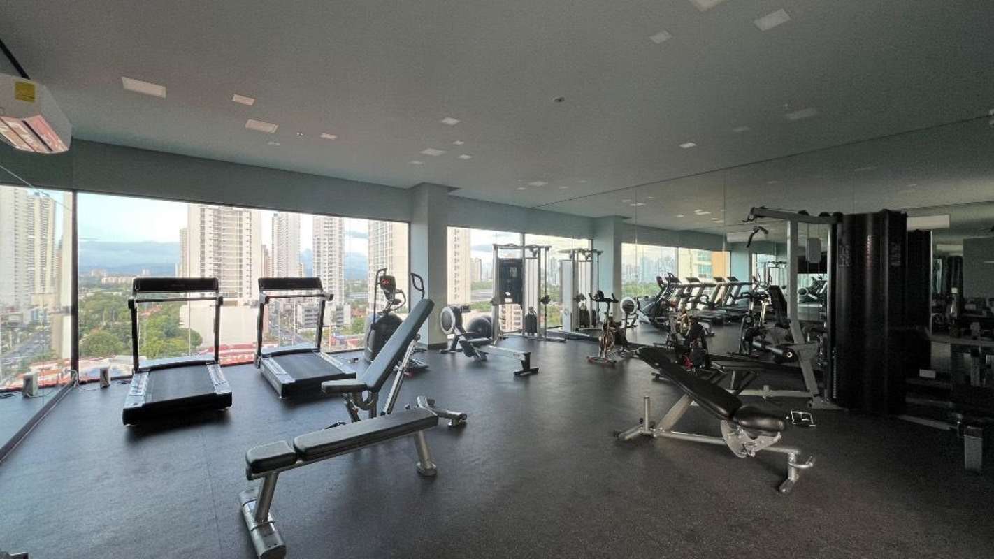 Fitness center with panoramic window views modern equipment at PH Coco Place Panama