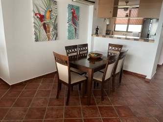 Guest bedroom with twin beds, ceiling fan at Playa Blanca Resort Panama beach condo