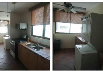 Dining space with ceiling fan, modern decor, open kitchen counter at Playa Blanca Resort Panama
