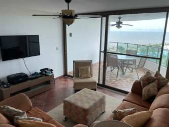 Living space with sofa, balcony access, ocean view at Playa Blanca Resort Panama