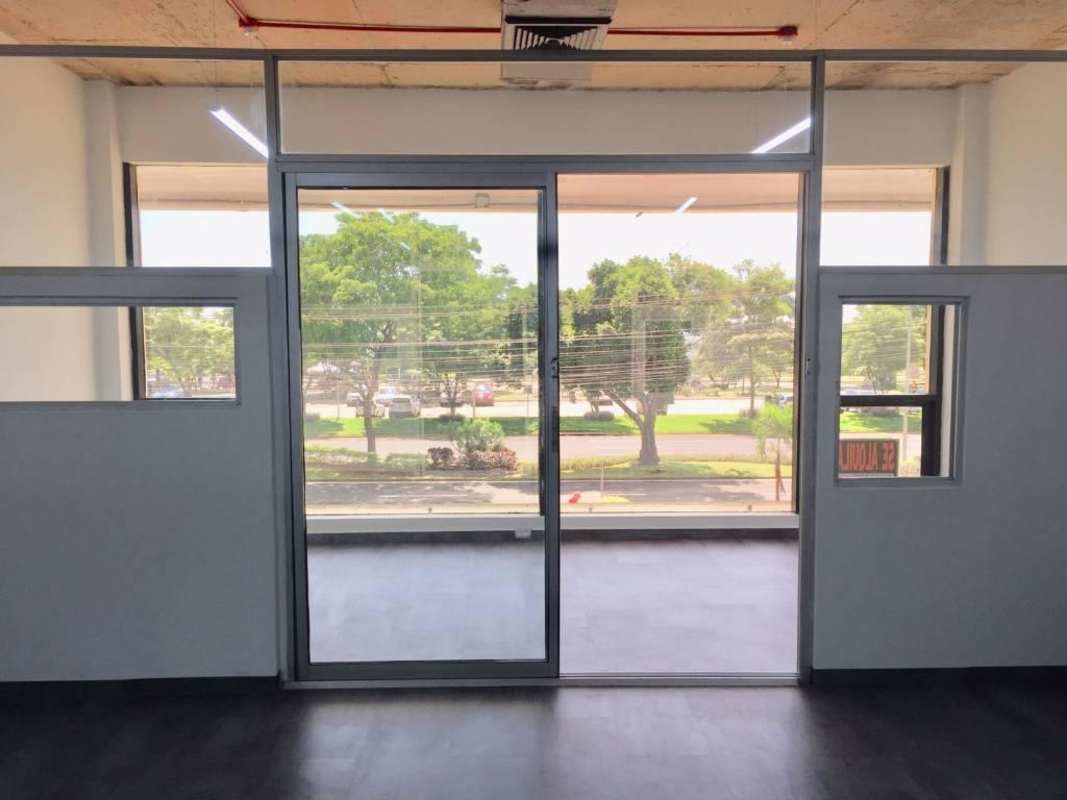 Modern corporate office space with large glass door at PH BICSA Tower in Panama City
