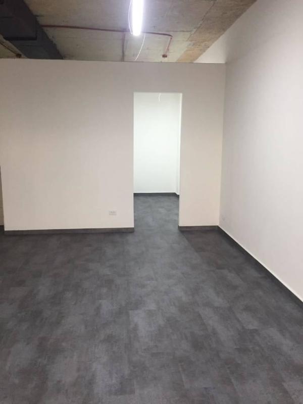 Interior modern office with glass wall partitions exposed ceiling at PH BICSA Tower Panama City