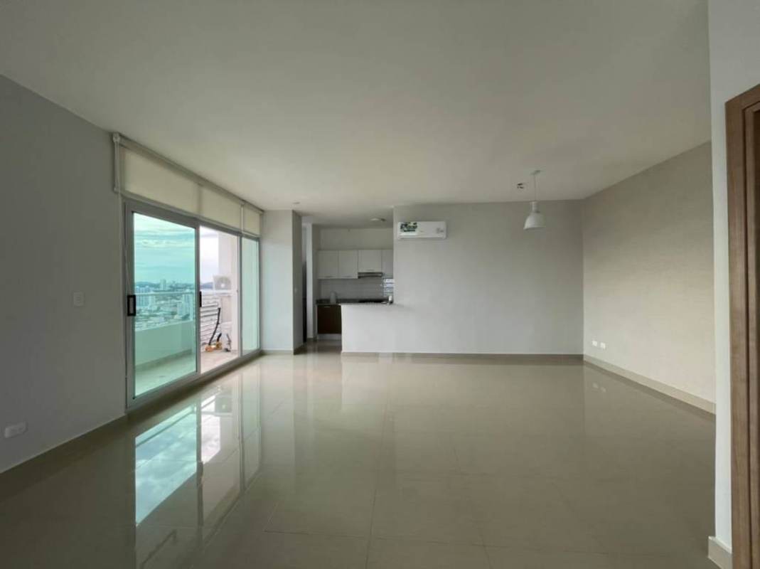 Living and dining area with tile floors and balcony overlooking city in PH Roma San Francisco Panama