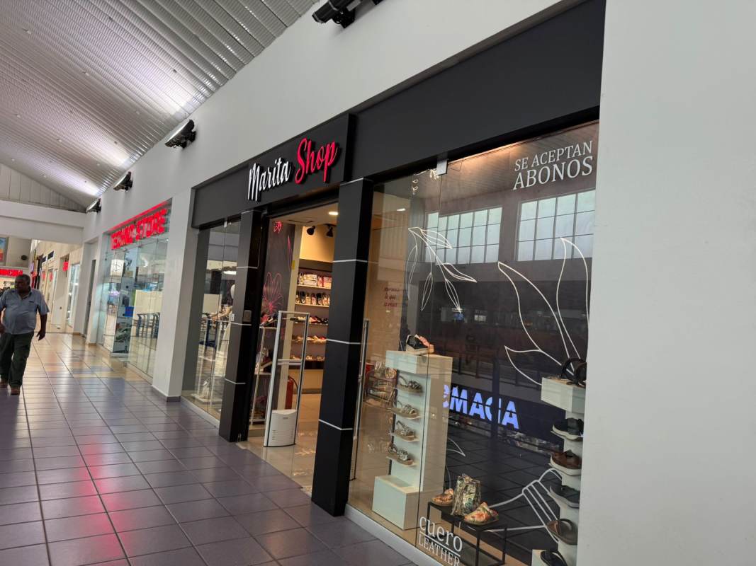 Panama shopping mall indoor corridor with storefronts glass windows and signage
