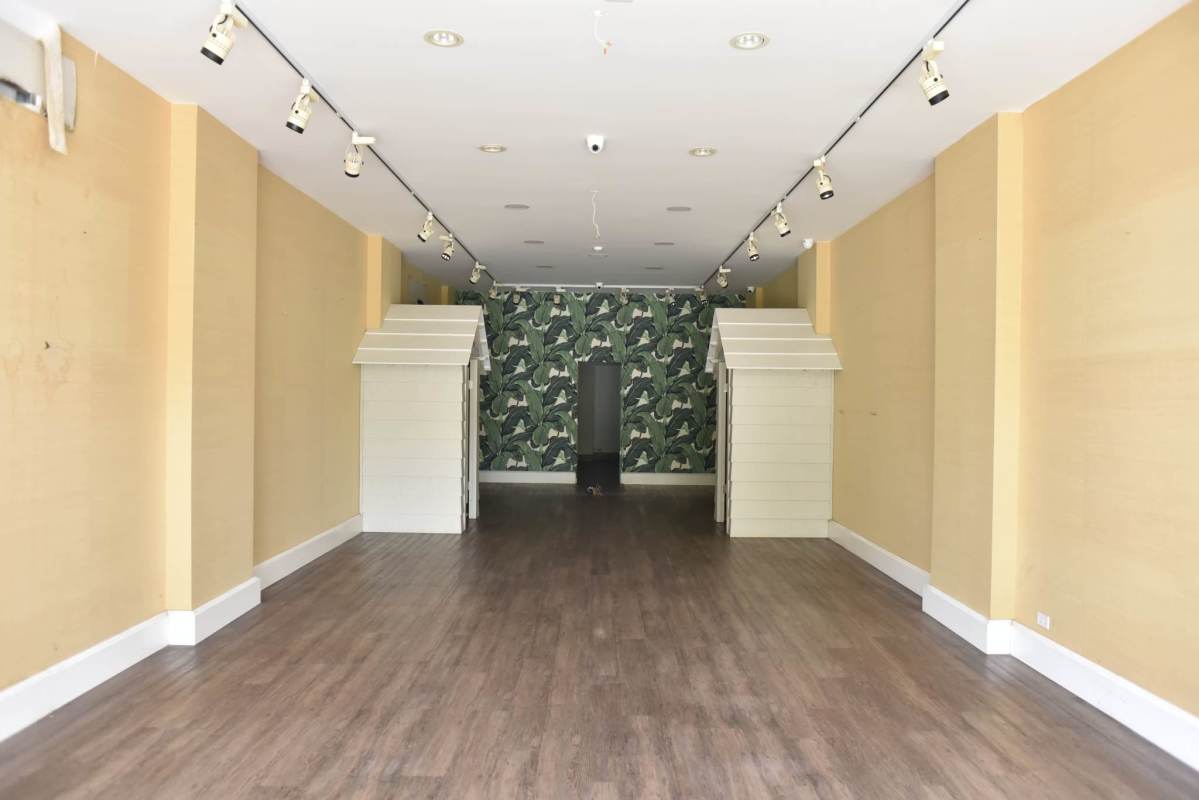 Vacant open commercial space with wooden floors, beige walls, decorative wallpaper, in Plaza San Francisco Panama City