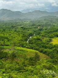 Overhead view of green valley, river and rolling hills with Anton Mountains in distance Penonomé Coclé land for sale
