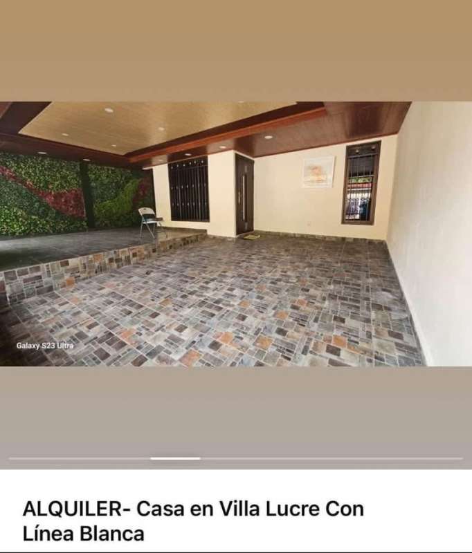 Covered exterior porch with multicolored tile, wooden ceiling, greenery wall in Villa Lucre home for rent Panama