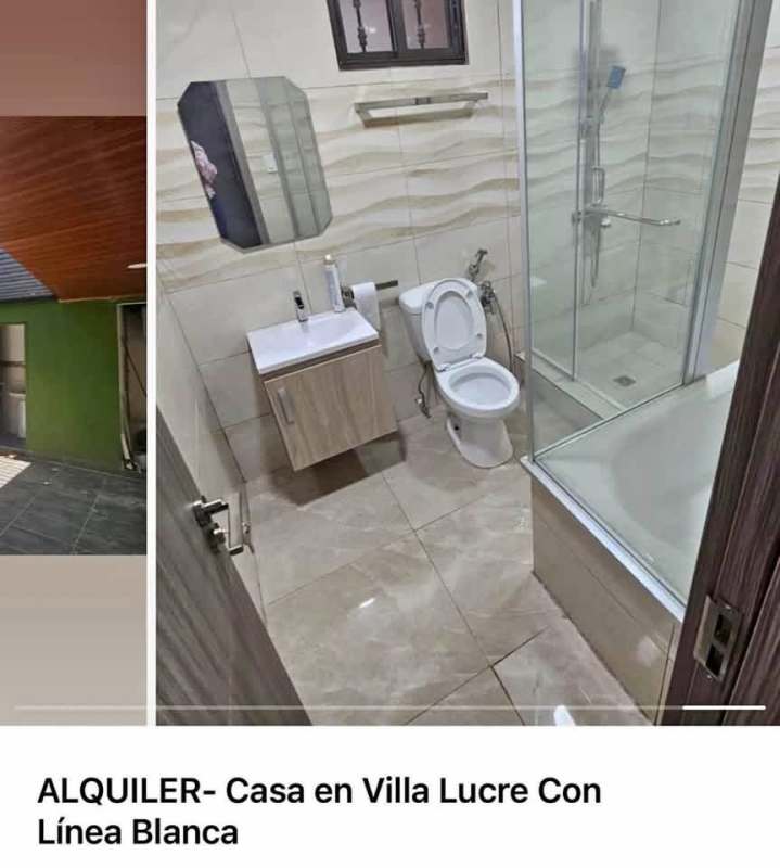 Bathroom with glass shower, wall-mounted sink vanity, beige ceramic tiles in Villa Lucre house Panama