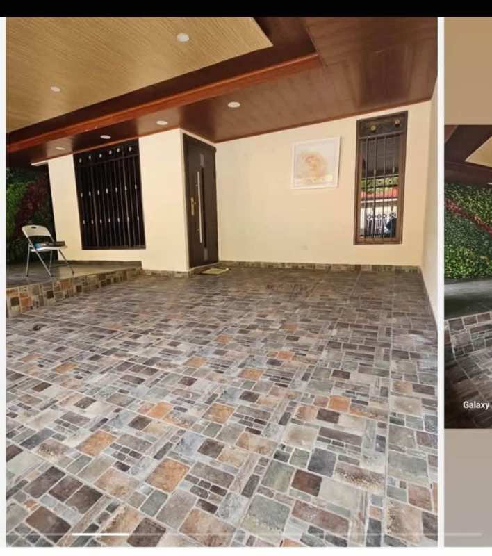 Entrance porch with multicolor tile flooring, metal window bars, wooden recessed ceiling in Villa Lucre Panama City
