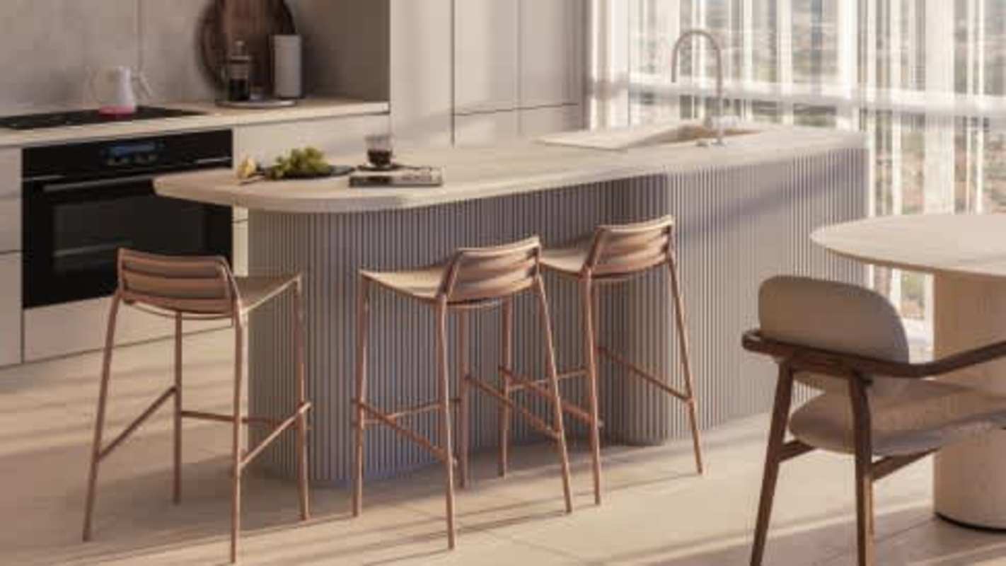 Minimalist kitchen with ribbed island quartz countertops bar stools BIOMA apartment Panama