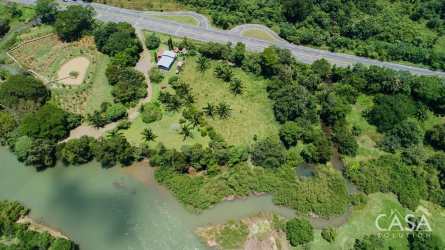 Aerial shot of open countryside, river, palms and farmland in Guabala Chiriquí Panama