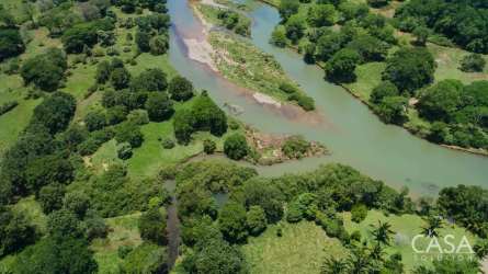 Bird's eye view of Santiago river bending through green countryside, wetlands, farmland in Guabala Chiriquí