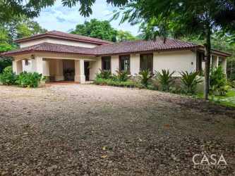 Spacious dining room and lounge with large windows and wood furniture Penonomé Panama