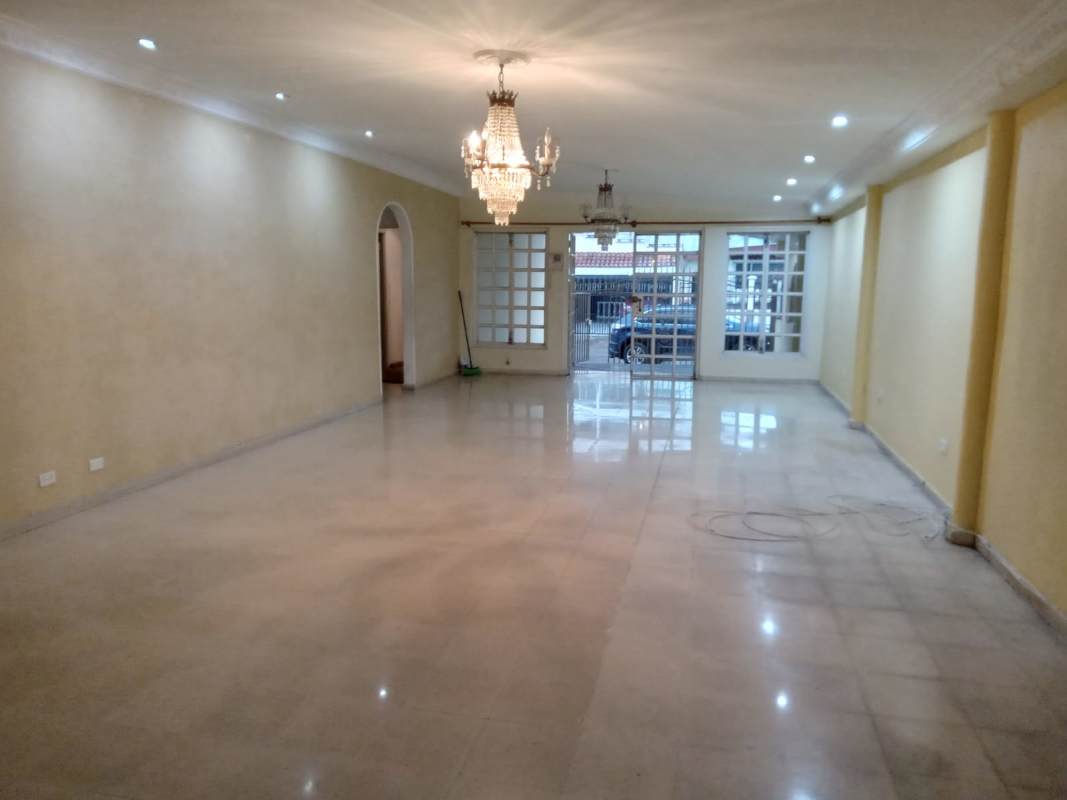 Spacious kitchen with double sink white cabinets and tiled walls in Villa de las Fuentes Panama City