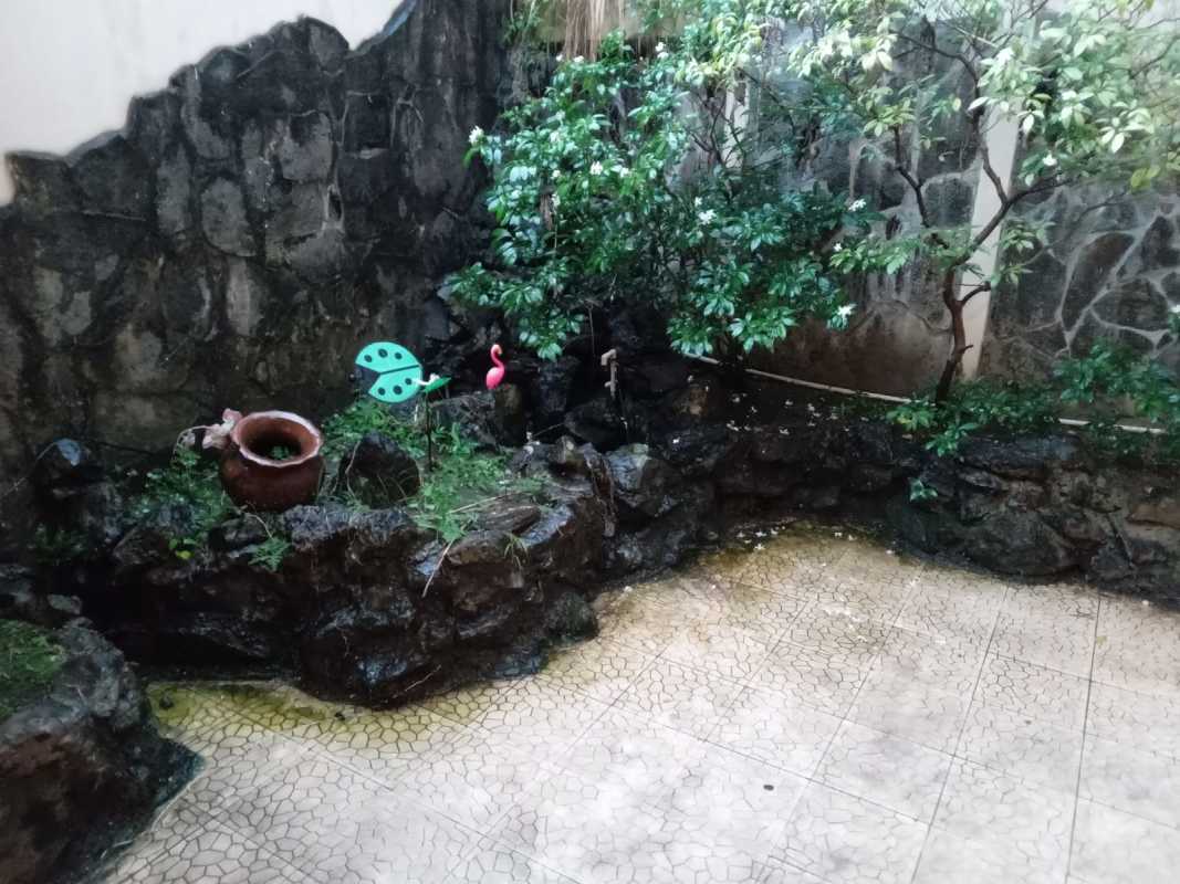 Outdoor garden area with stone wall plants and tiled flooring in Villa de las Fuentes El Dorado Panama