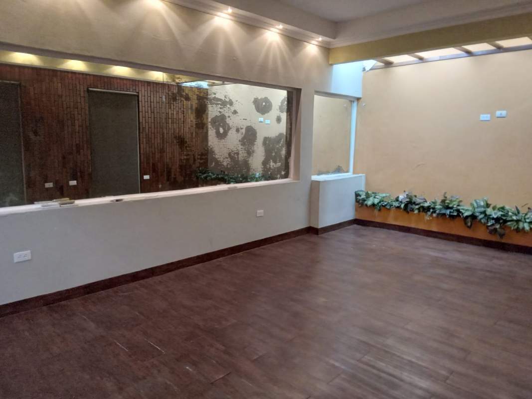 Bedroom with white cabinets built-in shelves window AC in Villa de las Fuentes Panama