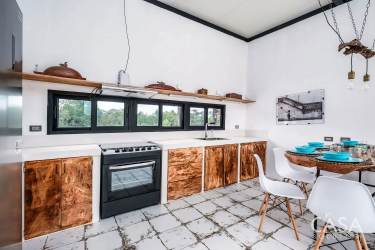 Open modern kitchen with natural light wooden cabinets Los Mangos del Rio Bijagual Chiriqui Panama