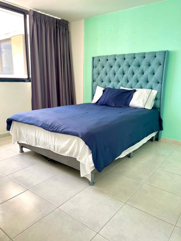 Bright tiled bathroom with glass shower enclosure in PH Fontana Obarrio Panama