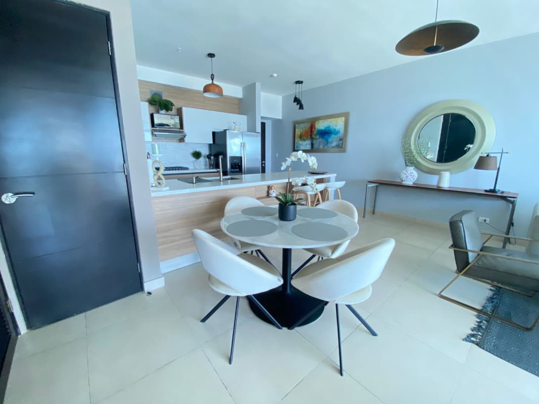 Dining area with modern furnishings and sea view window at PH BICSA Avenida Balboa Panama
