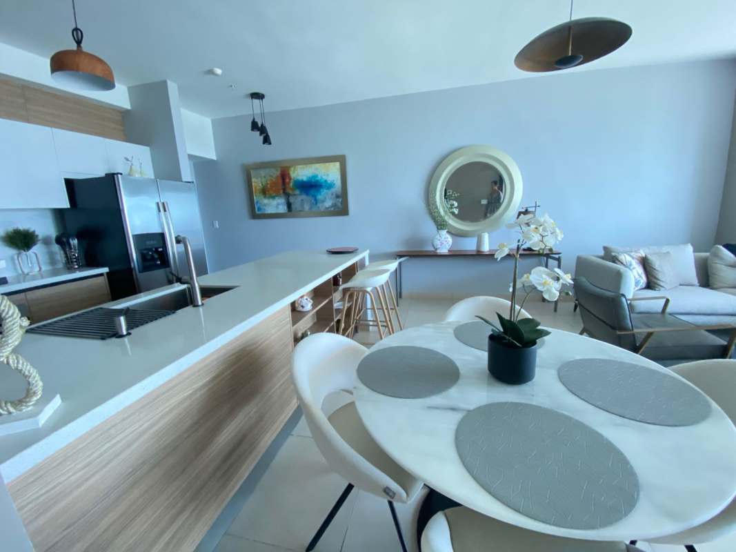 Open-concept furnished living room with panoramic sea views at PH BICSA Avenida Balboa Panama City