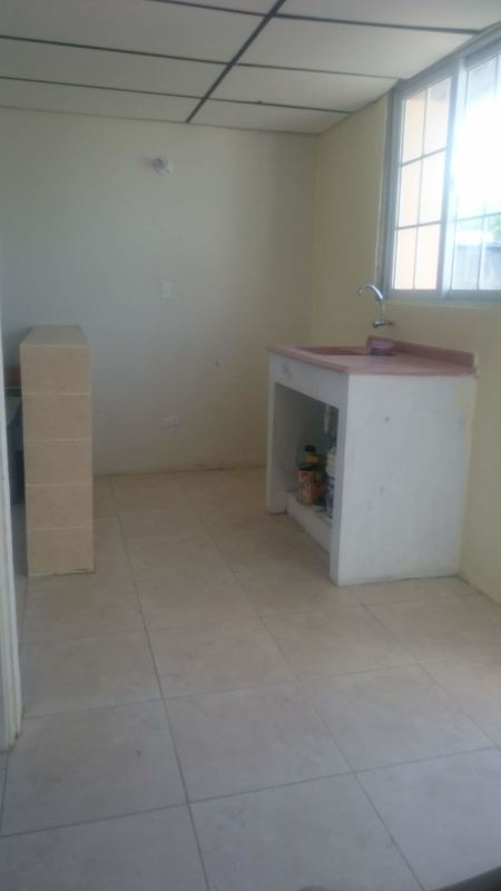 Simple interior living and dining space with tiled floors in budget rental house Nuevo Tocumen Panama