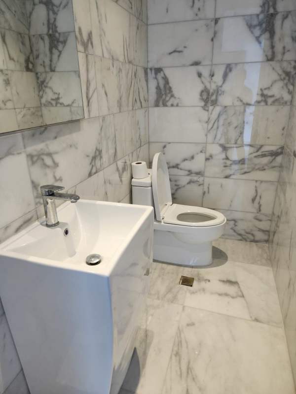 Marble-floored living and dining area with sea views at PH Ocean Front Punta Paitilla Panama City