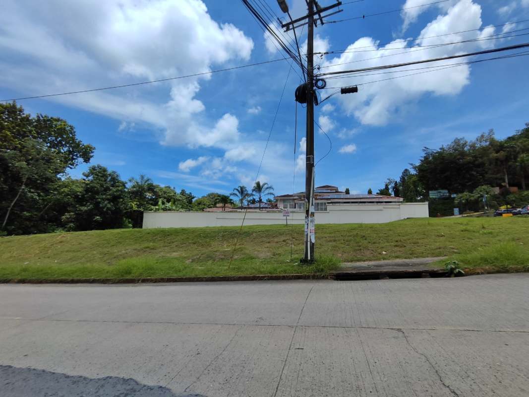 Vacant land plot with grass, sidewalk, utilities and residential area Albrook Panama