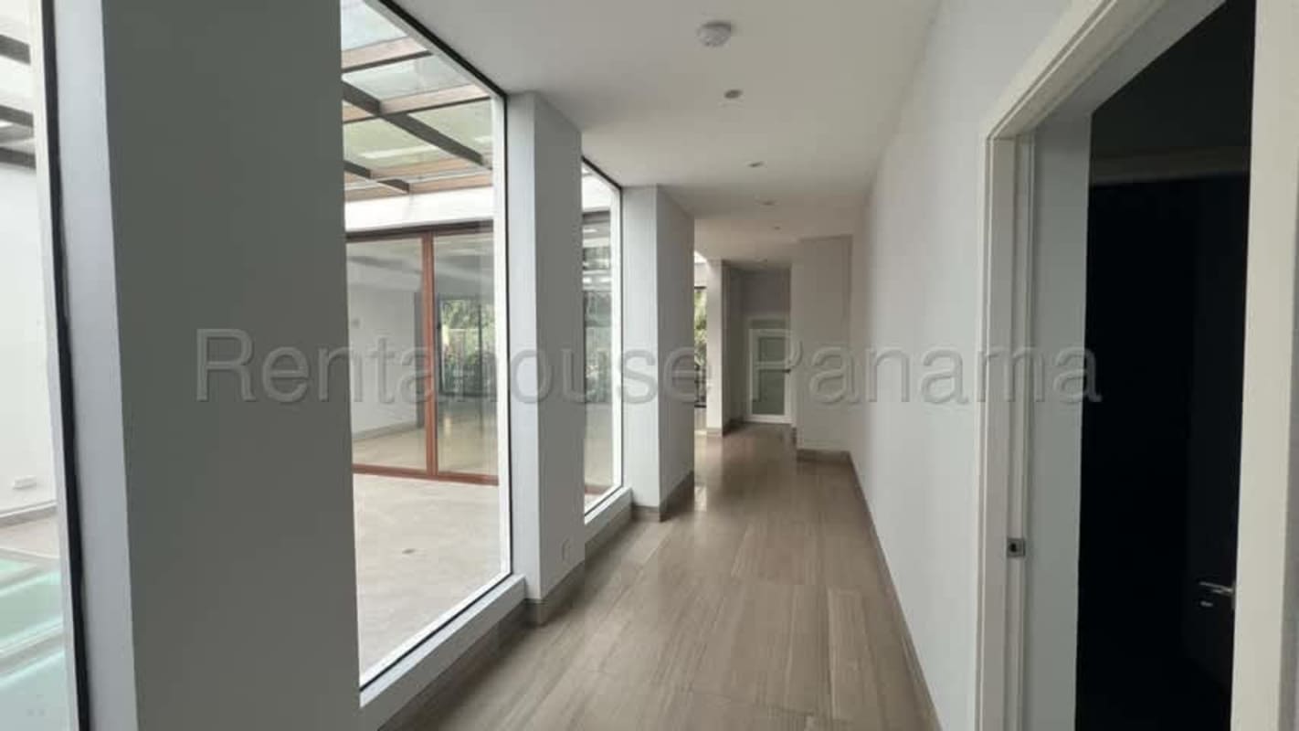 Bright spacious living room with high ceilings, ample glass windows and marble floors in luxury Clayton Panama house