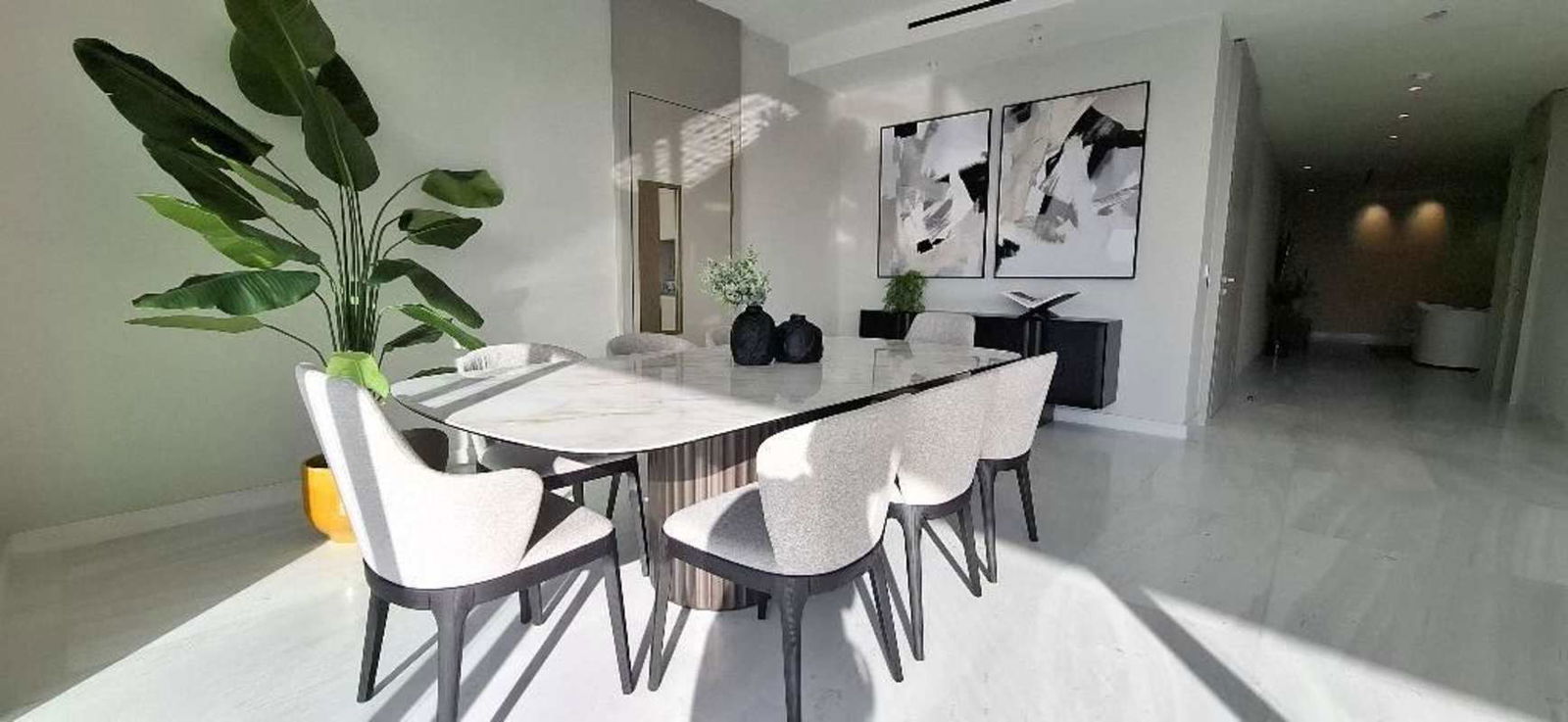 Bright luxury living room with city views, floor to ceiling windows marble floors La Maison Panama