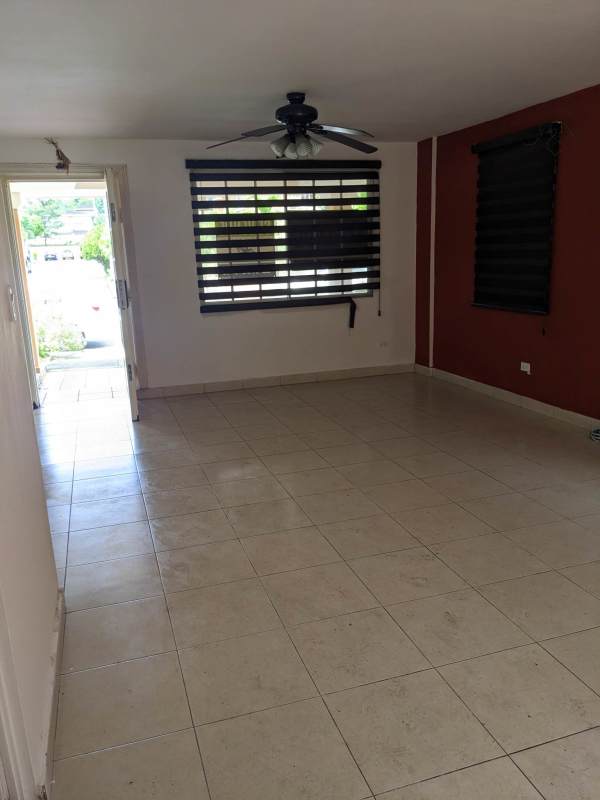 Family dining space with easy outdoor access, ceiling fan, large windows, and tiled flooring in Condado del Rey townhouse