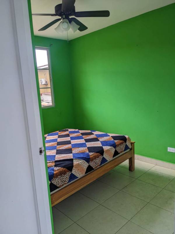 Bedroom featuring split AC, ceiling fan, closet and neutral decor in Dorado Lakes Panama townhouse