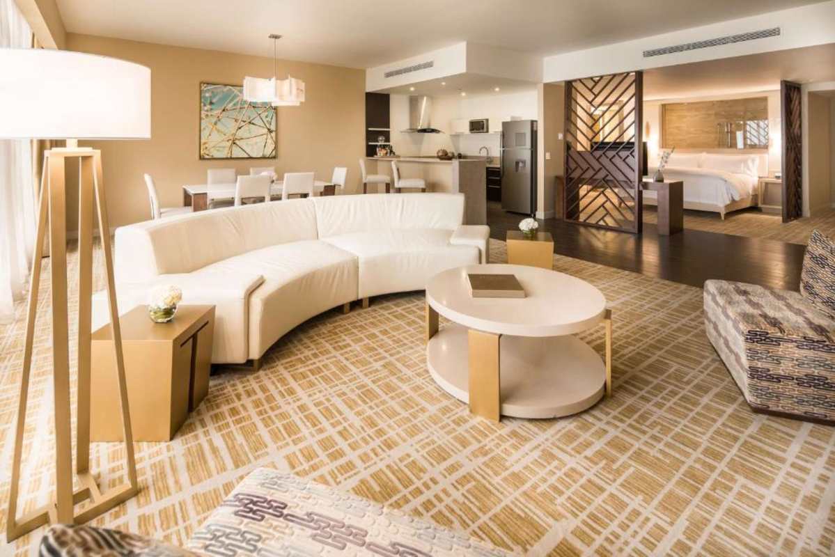 Modern luxury suite with open bedroom, kitchen, living at Waldorf Astoria Marbella Panama