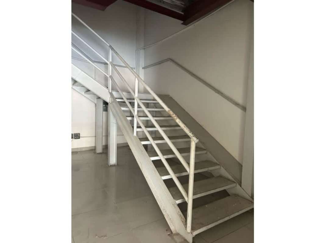Metal industrial staircase inside commercial unit at La Doña Shopping Center Panama