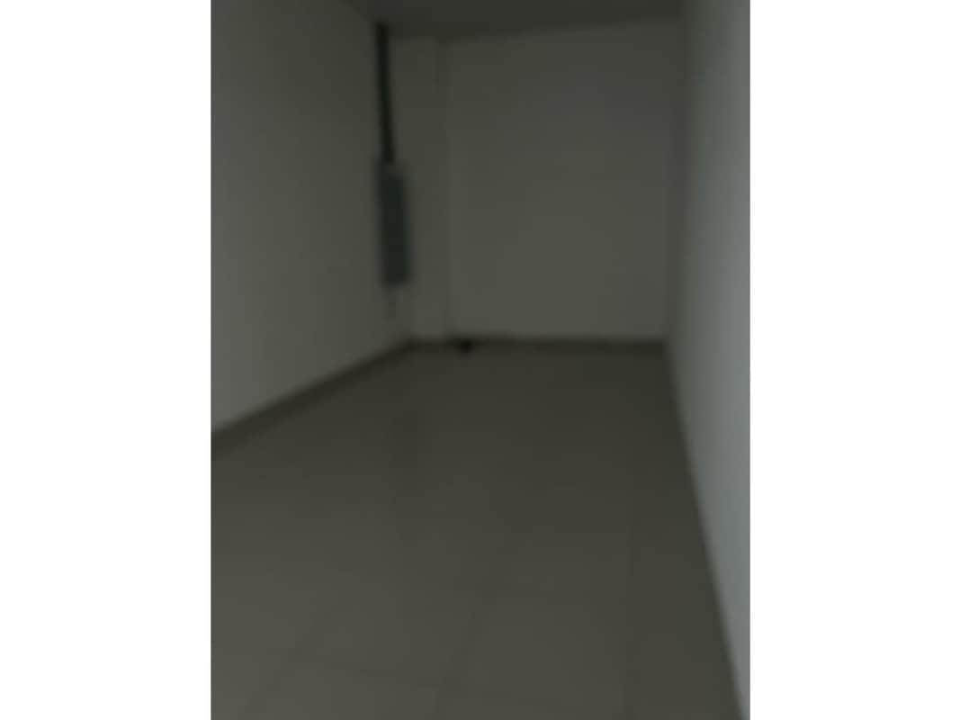 Modern interior commercial space with ceramic floor, white walls, lighting at La Doña Panama City