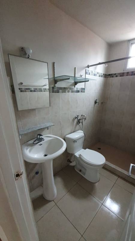 Bathroom with pedestal sink, shower, beige tiles PH Bella Vista Gardens Panama City