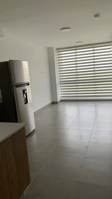 Living room in Forest Gate apartment with large windows overlooking greenery Albrook Panama