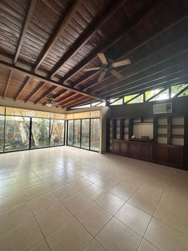 Wide living room with tall wood ceiling large windows in luxury Panama house Altos de Golf