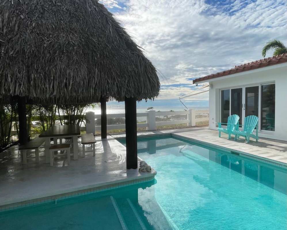 Spacious contemporary living room with marble flooring, large windows and Pacific Ocean view in luxury beach villa Panama