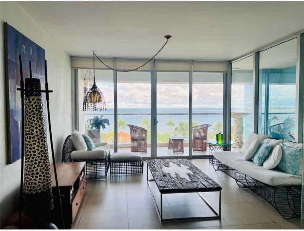Spacious living room with floor-to-ceiling windows, ocean views and balcony access in PH Rivage Tower Avenida Balboa Panama