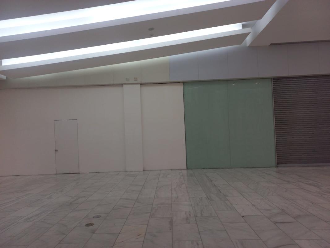 Colorful shopping mall concourse with miniature train ride and retail stores Albrook Mall Panama