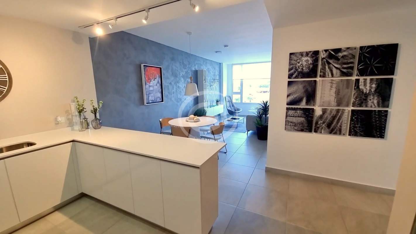 Kitchen with white cabinetry and breakfast bar Van Gogh Residences, Panama City