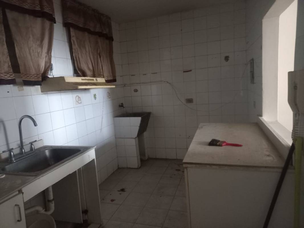 Living room with sofa, chairs, pass-through window to kitchen, tiled floor Plaza de Trafalgar Carrasquilla Panama